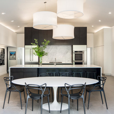 Eat-in kitchen - large contemporary galley eat-in kitchen idea in Denver with flat-panel cabinets, quartz countertops, white backsplash, stone slab backsplash, stainless steel appliances and an island