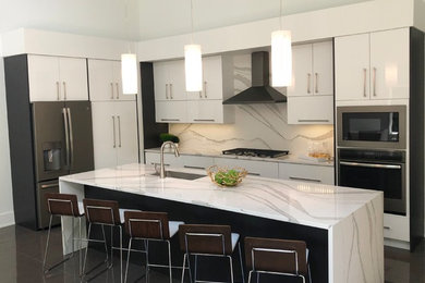 Medium sized modern l-shaped kitchen/diner in Other with white cabinets and an island.