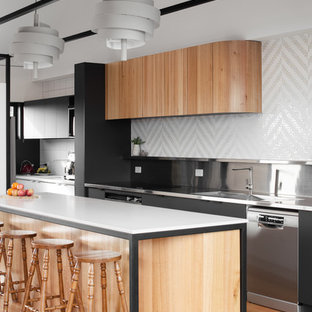 Design ideas for a contemporary galley kitchen in Hobart with an integrated sink, flat-panel cabinets, medium wood cabinets, stainless steel benchtops, white splashback, mosaic tile splashback, stainless steel appliances, medium hardwood floors, with island and brown floor.