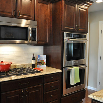 double wall oven, microwave over cooktop, maple cabs and hardwood floor