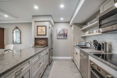 Example of a mid-sized trendy galley porcelain tile and gray floor kitchen design in Tampa with a single-bowl sink, recessed-panel cabinets, yellow cabinets, quartzite countertops, yellow backsplash, wood backsplash and stainless steel appliances
