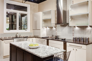 This is an example of a contemporary l-shaped kitchen/diner in Chicago with engineered stone countertops, a belfast sink, flat-panel cabinets, white cabinets and an island.