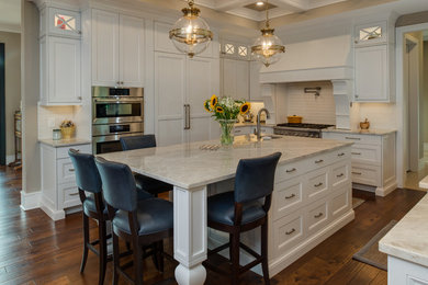 Large transitional u-shaped medium tone wood floor and brown floor eat-in kitchen photo in Detroit with an undermount sink, beaded inset cabinets, white cabinets, quartzite countertops, white backsplash, porcelain backsplash, paneled appliances, an island and white countertops