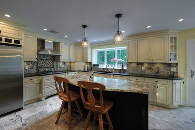 Example of a mid-sized eclectic l-shaped porcelain tile eat-in kitchen design in Philadelphia with a double-bowl sink, raised-panel cabinets, white cabinets, granite countertops, gray backsplash, porcelain backsplash, stainless steel appliances and an island