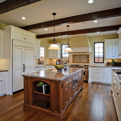Example of a classic kitchen design in San Francisco with raised-panel cabinets, white cabinets, beige backsplash, subway tile backsplash and paneled appliances