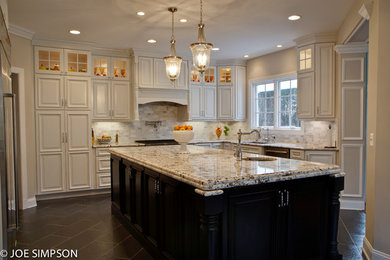 Elegant u-shaped eat-in kitchen photo in DC Metro with an undermount sink, raised-panel cabinets, white cabinets, granite countertops, multicolored backsplash, stone tile backsplash and stainless steel appliances