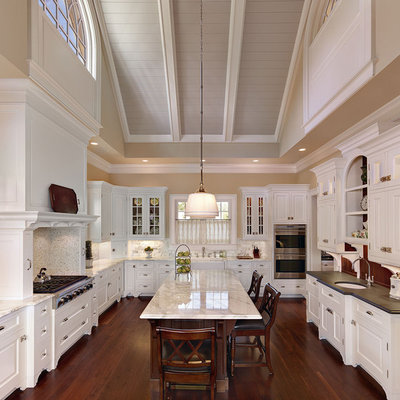 Elegant u-shaped kitchen photo in Charleston with raised-panel cabinets, white cabinets, white backsplash and an undermount sink