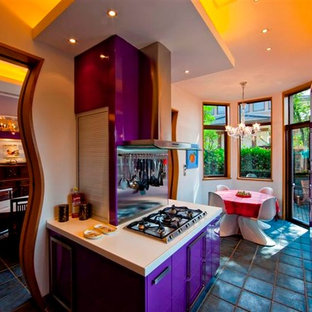 Design ideas for a large eclectic galley eat-in kitchen in Other with flat-panel cabinets, limestone benchtops, white splashback, stainless steel appliances and a peninsula.