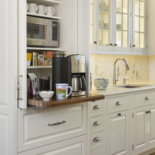 This is an example of an expansive traditional open plan kitchen in Boston with raised-panel cabinets, white cabinets, multi-coloured splashback, stainless steel appliances, medium hardwood floors, with island, limestone benchtops, porcelain splashback, brown floor and beige benchtop.