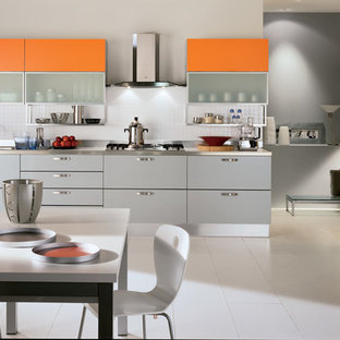 Large modern eat-in kitchen remodeling - Eat-in kitchen - large modern l-shaped ceramic tile eat-in kitchen idea in Melbourne with a double-bowl sink, raised-panel cabinets, orange cabinets, stainless steel countertops, white backsplash, ceramic backsplash, stainless steel appliances and two islands