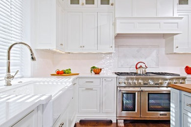 Inspiration for a large contemporary l-shaped medium tone wood floor kitchen remodel in DC Metro with a farmhouse sink, beaded inset cabinets, white cabinets, quartz countertops, white backsplash, subway tile backsplash, stainless steel appliances and an island