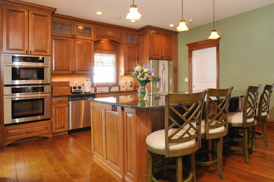Elegant l-shaped eat-in kitchen photo in Other with medium tone wood cabinets, stainless steel appliances and an island