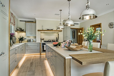 Inspiration for a traditional kitchen in Other with shaker cabinets, medium hardwood flooring and a breakfast bar.