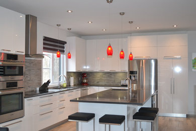 Large minimalist l-shaped vinyl floor and beige floor open concept kitchen photo in Montreal with an undermount sink, flat-panel cabinets, white cabinets, granite countertops, gray backsplash, ceramic backsplash, stainless steel appliances, an island and gray countertops