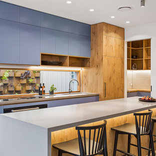 Mid-sized contemporary galley eat-in kitchen in Melbourne with an undermount sink, medium wood cabinets, concrete benchtops, window splashback, concrete floors, with island, grey floor, grey benchtop and flat-panel cabinets.