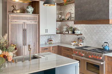Kitchen - transitional l-shaped medium tone wood floor and brown floor kitchen idea in San Francisco with an undermount sink, shaker cabinets, medium tone wood cabinets, white backsplash, stainless steel appliances, an island and white countertops
