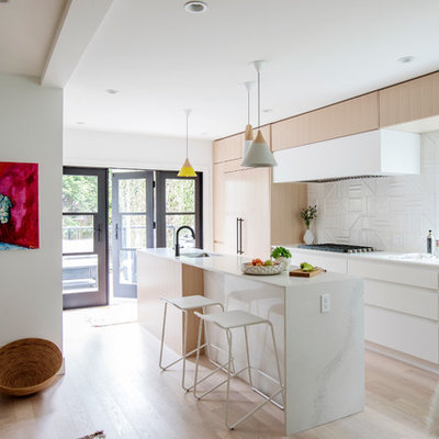Kitchen - scandinavian galley light wood floor and beige floor kitchen idea in Vancouver with an undermount sink, flat-panel cabinets, white cabinets, white backsplash, paneled appliances, an island and quartz countertops
