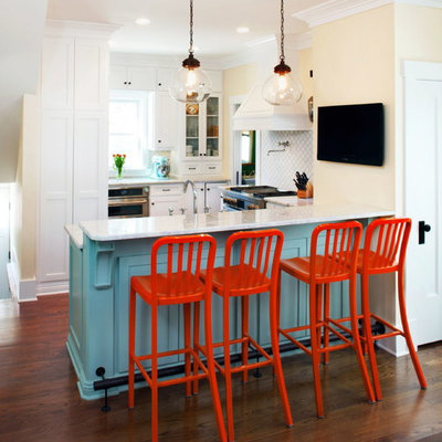 Elegant eat-in kitchen photo in Omaha with a farmhouse sink, white cabinets, granite countertops, stainless steel appliances and white backsplash