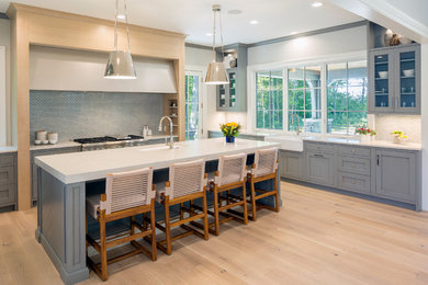 Inspiration for a huge transitional u-shaped light wood floor and beige floor open concept kitchen remodel in Grand Rapids with an undermount sink, shaker cabinets, gray cabinets, quartz countertops, metallic backsplash, paneled appliances, an island and white countertops