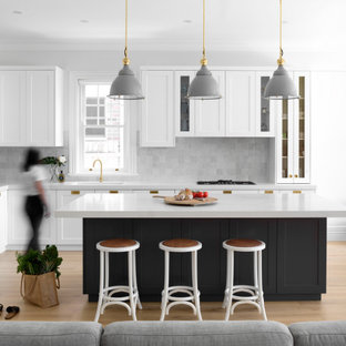 Inspiration for a large transitional l-shaped open plan kitchen in Sydney with an undermount sink, shaker cabinets, grey cabinets, quartz benchtops, grey splashback, ceramic splashback, stainless steel appliances, light hardwood floors, with island, beige floor and yellow benchtop.