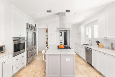 Large trendy u-shaped limestone floor and beige floor open concept kitchen photo in Miami with a single-bowl sink, raised-panel cabinets, gray cabinets, marble countertops, beige backsplash, marble backsplash, stainless steel appliances, an island and beige countertops