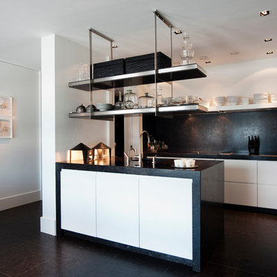 Inspiration for a modern l-shaped kitchen remodel in New York with flat-panel cabinets and black backsplash