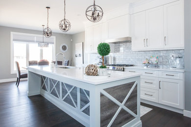 Eat-in kitchen - mid-sized contemporary l-shaped medium tone wood floor and brown floor eat-in kitchen idea in Toronto with flat-panel cabinets, white cabinets, quartz countertops, stainless steel appliances and an island