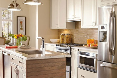 Example of a mid-sized transitional single-wall brown floor eat-in kitchen design in Austin with an undermount sink, recessed-panel cabinets, white cabinets, granite countertops, brown backsplash, stainless steel appliances, an island and beige countertops