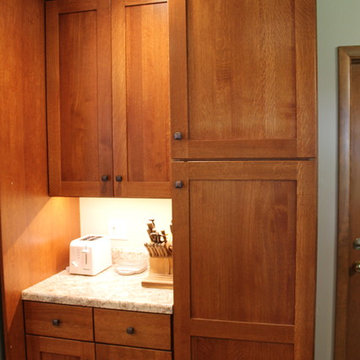 Dynasty by Omega Cabinetry. Monterey door, Quarter sawn oak wood, Nutmeg stain.