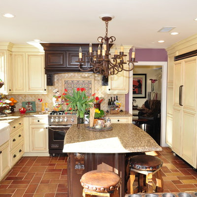 Example of a classic u-shaped enclosed kitchen design in Los Angeles with a farmhouse sink, raised-panel cabinets, beige cabinets, beige backsplash and paneled appliances