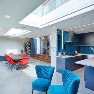 Inspiration for a medium sized contemporary u-shaped kitchen/diner in London with flat-panel cabinets, quartz worktops, ceramic splashback, integrated appliances, ceramic flooring, an island, grey floors, grey worktops, a belfast sink, blue cabinets and blue splashback.