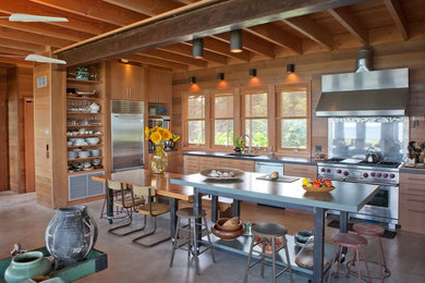 Eat-in kitchen - large coastal l-shaped concrete floor eat-in kitchen idea in Boston with light wood cabinets, stainless steel appliances, an undermount sink, open cabinets, glass sheet backsplash and an island