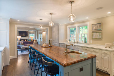 Inspiration for a large transitional u-shaped dark wood floor open concept kitchen remodel in Orange County with raised-panel cabinets, white cabinets, marble countertops, an island, metallic backsplash, glass tile backsplash, a farmhouse sink and stainless steel appliances