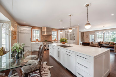 Inspiration for a large contemporary single-wall medium tone wood floor open concept kitchen remodel in New York with an undermount sink, white cabinets, stainless steel appliances, an island, shaker cabinets, quartz countertops, beige backsplash and wood backsplash