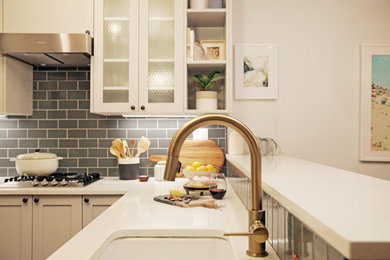 Small transitional u-shaped slate floor eat-in kitchen photo in New York with an undermount sink, shaker cabinets, gray cabinets, quartz countertops, gray backsplash, subway tile backsplash, stainless steel appliances and a peninsula