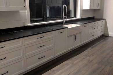 Inspiration for a modern dark wood floor kitchen remodel in Other with shaker cabinets and no island