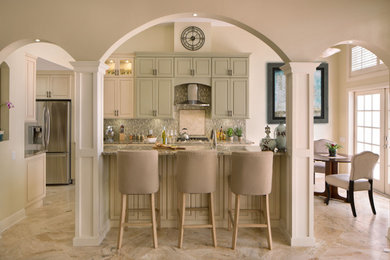 Eat-in kitchen - mid-sized transitional galley travertine floor eat-in kitchen idea with an island, raised-panel cabinets, white cabinets, granite countertops, green backsplash, glass tile backsplash, stainless steel appliances and an undermount sink