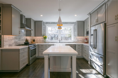 Eat-in kitchen - mid-sized transitional u-shaped dark wood floor eat-in kitchen idea in San Francisco with a farmhouse sink, solid surface countertops, gray backsplash, marble backsplash, stainless steel appliances, shaker cabinets, gray cabinets and an island
