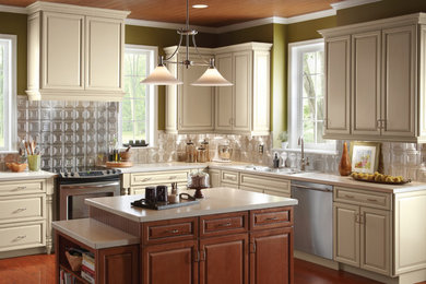 Example of a mid-sized trendy l-shaped dark wood floor kitchen design in DC Metro with a double-bowl sink, raised-panel cabinets, beige cabinets, solid surface countertops, metallic backsplash, metal backsplash, stainless steel appliances and an island