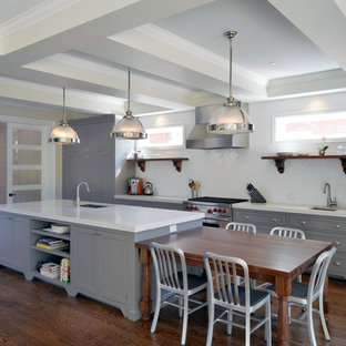 Design ideas for a large modern galley eat-in kitchen in Ottawa with an integrated sink, recessed-panel cabinets, grey cabinets, quartzite benchtops, white splashback, subway tile splashback, stainless steel appliances, medium hardwood floors and with island.