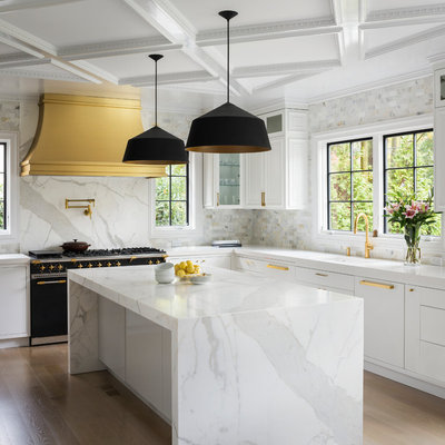 Trendy l-shaped light wood floor and beige floor kitchen photo in New York with an undermount sink, recessed-panel cabinets, white cabinets, multicolored backsplash, black appliances, an island and multicolored countertops