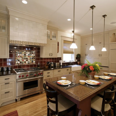 Inspiration for an eclectic kitchen remodel in Minneapolis with paneled appliances, a farmhouse sink, beige cabinets, quartz countertops, red backsplash and ceramic backsplash