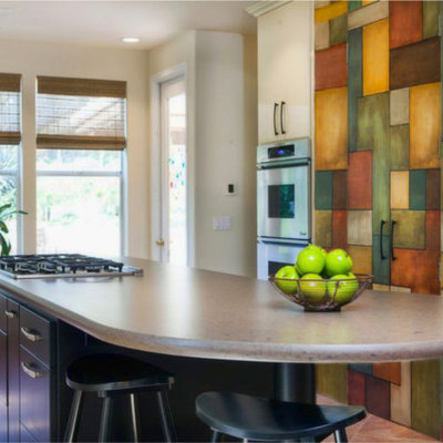 Enclosed kitchen - mid-sized eclectic galley porcelain tile enclosed kitchen idea in San Diego with flat-panel cabinets, multicolored backsplash, stainless steel appliances, a single-bowl sink, beige cabinets, quartz countertops, ceramic backsplash and an island