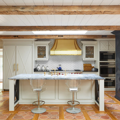 Example of a mid-sized eclectic l-shaped terra-cotta tile and orange floor open concept kitchen design in Nashville with recessed-panel cabinets, blue cabinets, white backsplash, paneled appliances, an island, an undermount sink, quartzite countertops and ceramic backsplash