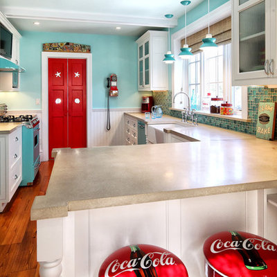 Elegant galley enclosed kitchen photo in Philadelphia with a farmhouse sink, glass-front cabinets, white cabinets, concrete countertops and colored appliances