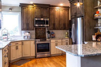 Inspiration for a mid-sized cottage medium tone wood floor and brown floor eat-in kitchen remodel in Other with an undermount sink, raised-panel cabinets, distressed cabinets, quartz countertops, subway tile backsplash, stainless steel appliances, a peninsula and white countertops