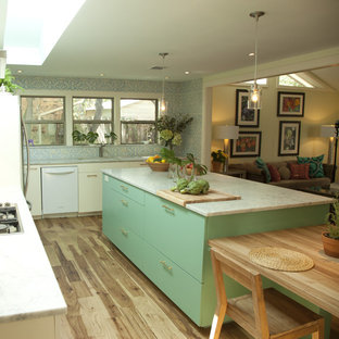 Photo of an eclectic kitchen in Austin with marble benchtops, white appliances, flat-panel cabinets and turquoise cabinets.