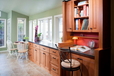 Large modern u-shaped kitchen/diner in Omaha with raised-panel cabinets, light wood cabinets, laminate countertops, ceramic flooring, a built-in sink, grey splashback, mosaic tiled splashback, stainless steel appliances and an island.