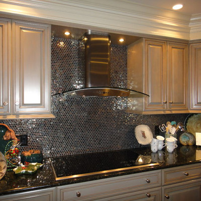 Example of a mid-sized eclectic l-shaped medium tone wood floor open concept kitchen design in Little Rock with an undermount sink, gray cabinets, granite countertops, metallic backsplash, glass tile backsplash, stainless steel appliances and an island
