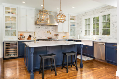 Eat-in kitchen - mid-sized transitional u-shaped medium tone wood floor and brown floor eat-in kitchen idea in San Francisco with a farmhouse sink, blue cabinets, marble countertops, gray backsplash, marble backsplash, stainless steel appliances, an island and recessed-panel cabinets